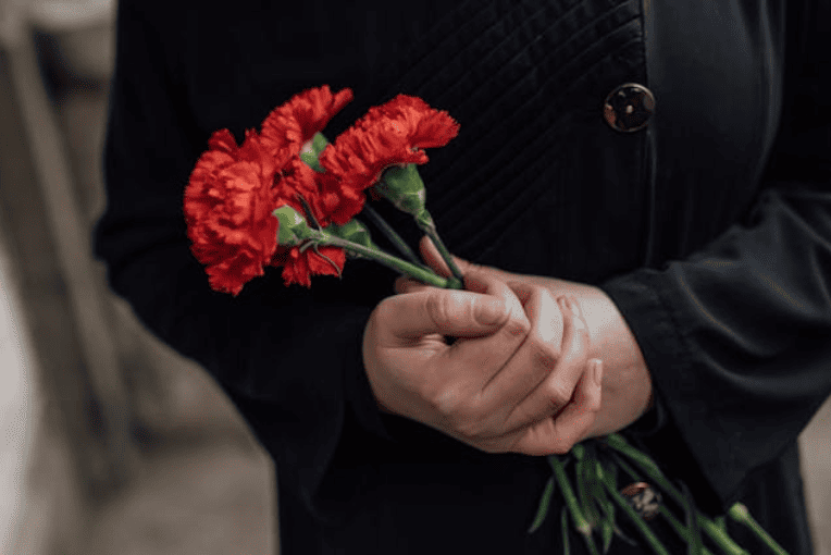 a person bringing flowers when attending a funeral and cremation in Tacoma, WA